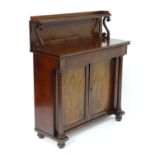 A William IV mahogany chiffonier, having a raised gallery with a shaped upstand supported by