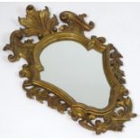 An early / mid 20thC giltwood mirror with a carved floral frame. 28" high x 16" wide. Please