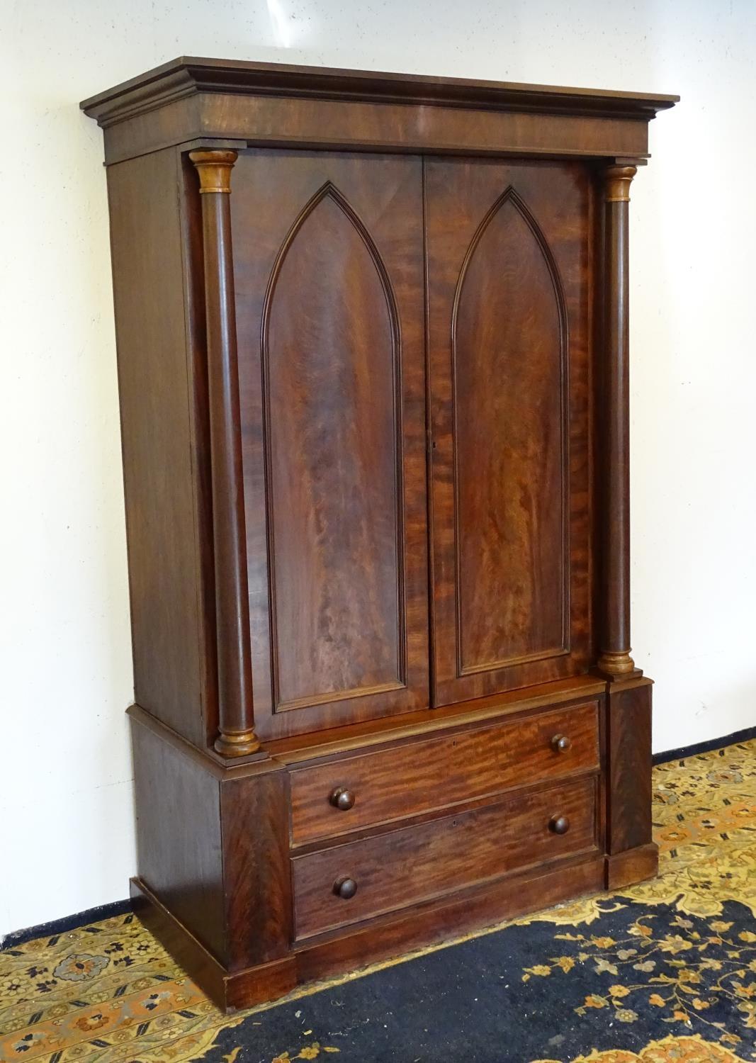 A 19thC mahogany press with a moulded cornice above two large doors with lancet shaped panelling, - Bild 6 aus 7