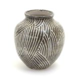 A studio pottery vase of squat baluster form, with monochrome decoration. Incised maker's mark