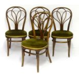 A set of four late 19thC Thonet bentwood chairs with shaped backrests and upholstered seats above