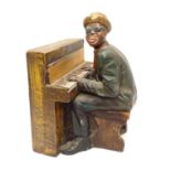 A 20thC model of a black gentleman playing the piano, possibly Ray Charles. Approx. 15 1/2" high