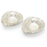 A pair of late Victorian silver heart-shaped bonbon dishes with pierced and scroll decoration,