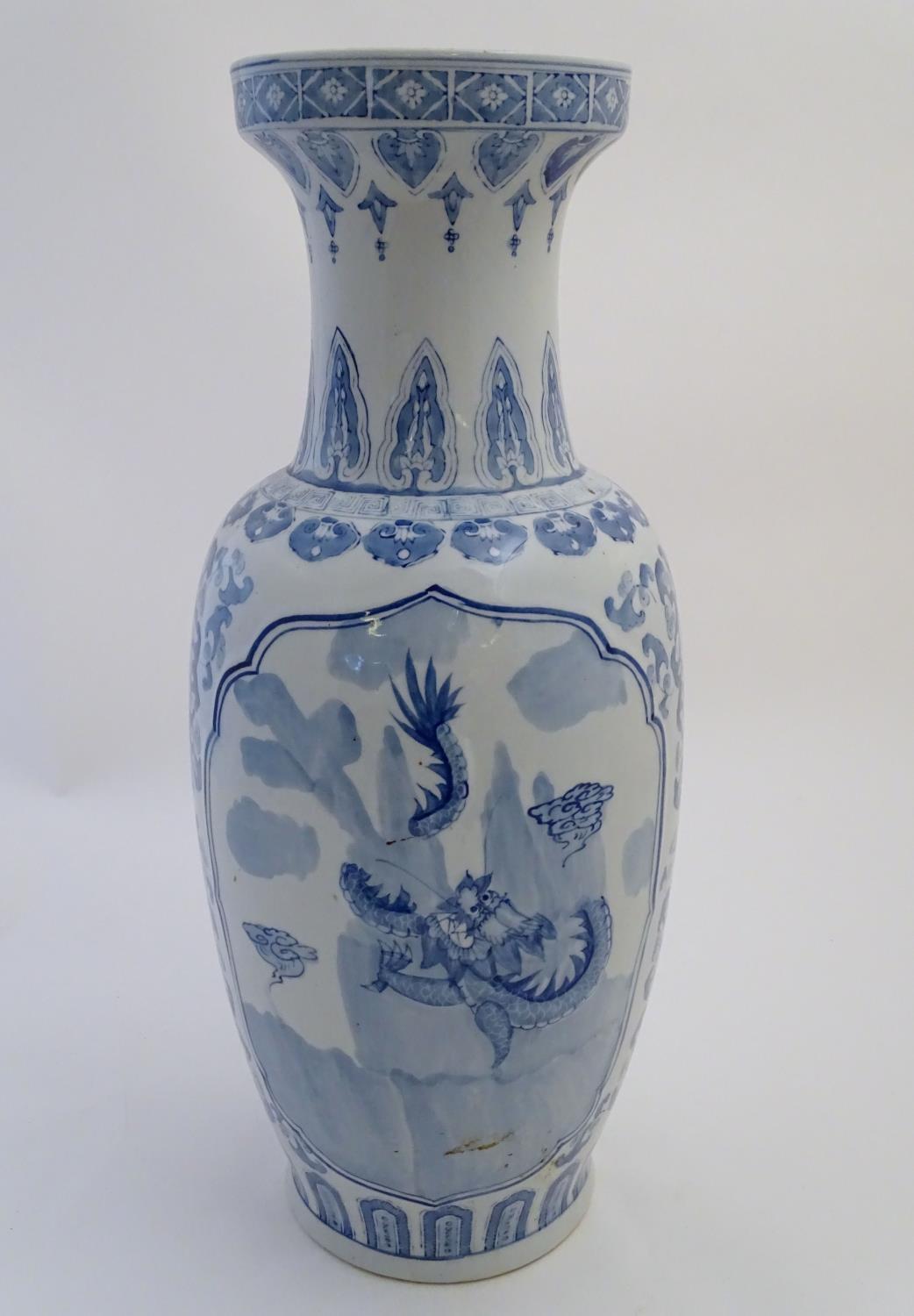 A large Chinese blue and white vase decorated with flowers, foliage and a stylised phoenix and - Image 6 of 10