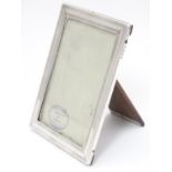 A photograph frame with silver surround hallmarked Birmingham 1918 maker William Neale & Son Ltd. 6"