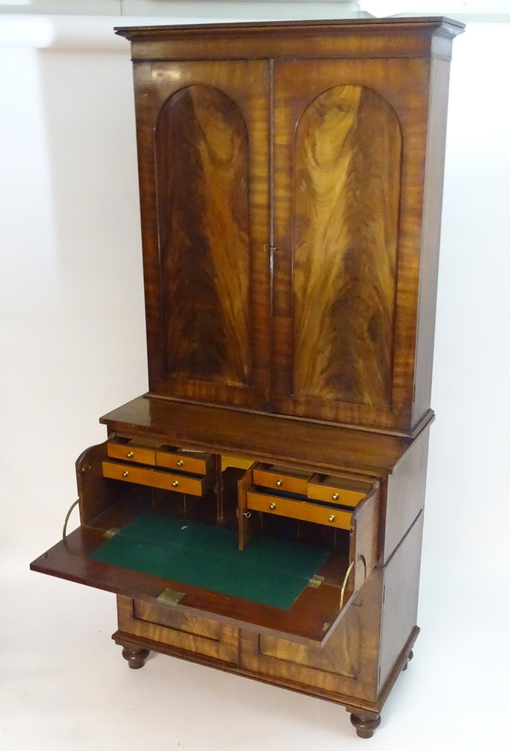 A mid 19thC mahogany secretaire bookcase, having a moulded cornice above two flame mahogany panelled - Bild 2 aus 8