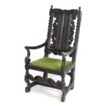 A 19thC carved ebonised open armchair with scrolled decoration and barley twists supports above a