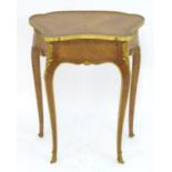 A late 19thC kingwood table in the manner of Francois Linke with a shaped top, gilt stringing and