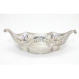 A Silver boat-shaped dish with scroll ends and pierced decoration. Bears a small yacht style mark