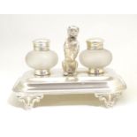 A silver plate desk standish with two glass inkwells and a model of a begging dog to centre. Approx.