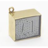 A novelty 9ct gold pendant charm of squared form. Engraved ' In Emergency break glass' and