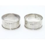 A pair of silver napkin rings with engine turned banded decoration. Hallmarked Birmingham 1921 maker