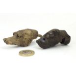 Two late 19th / early 20thC carved wooden dog heads, one a whistle. Largest approx. 2 1/2" long