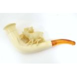 An early 20thC cased ladies' carved meerschaum pipe, the bowl formed as a stag amongst foliage, with