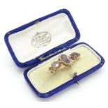 A Victorian brooch set with facet cut amethyst and seed pearls 1 1/2" wide Please Note - we do not