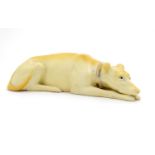 A 20thC porcelain model of a recumbent greyhound dog with a gilt collar. Approx. 8 1/4" long