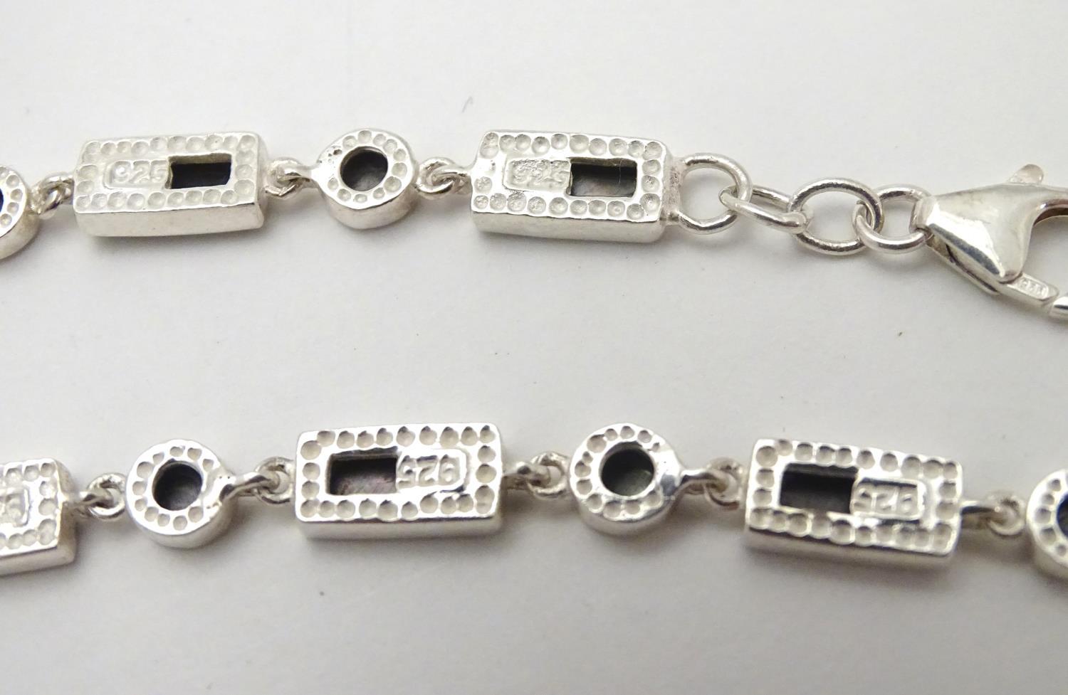 A silver bracelet set with abalone shell detail together with and 3 assorted charms (4) Please - Image 2 of 8