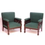 A pair of late 19thC mahogany armchairs with an upholstered backrest and seat, having lions masks