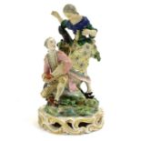 A Continental porcelain figural group with two figures, a kneeling gentleman fitting a slipper on