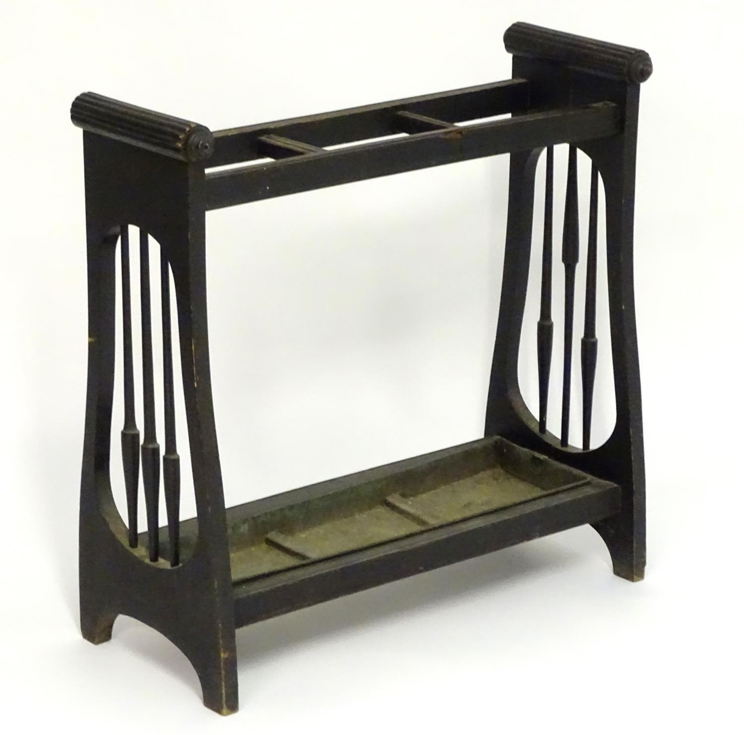 A 19thC Aesthetic movement stick stand with a three sectional centre, turned tapering spindles to