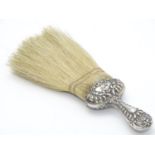 A silver handled hat brush with embossed decoration. Hallmarked Chester 1902 maker J C Plimpton & Co