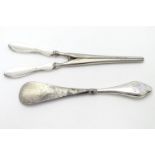 A silver handled shoe horn together with silver handled glove stretcher . the largest 7 1/2" long