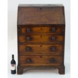 A Georgian mahogany bureau of small proportions, having a fall front containing pigeon holes and