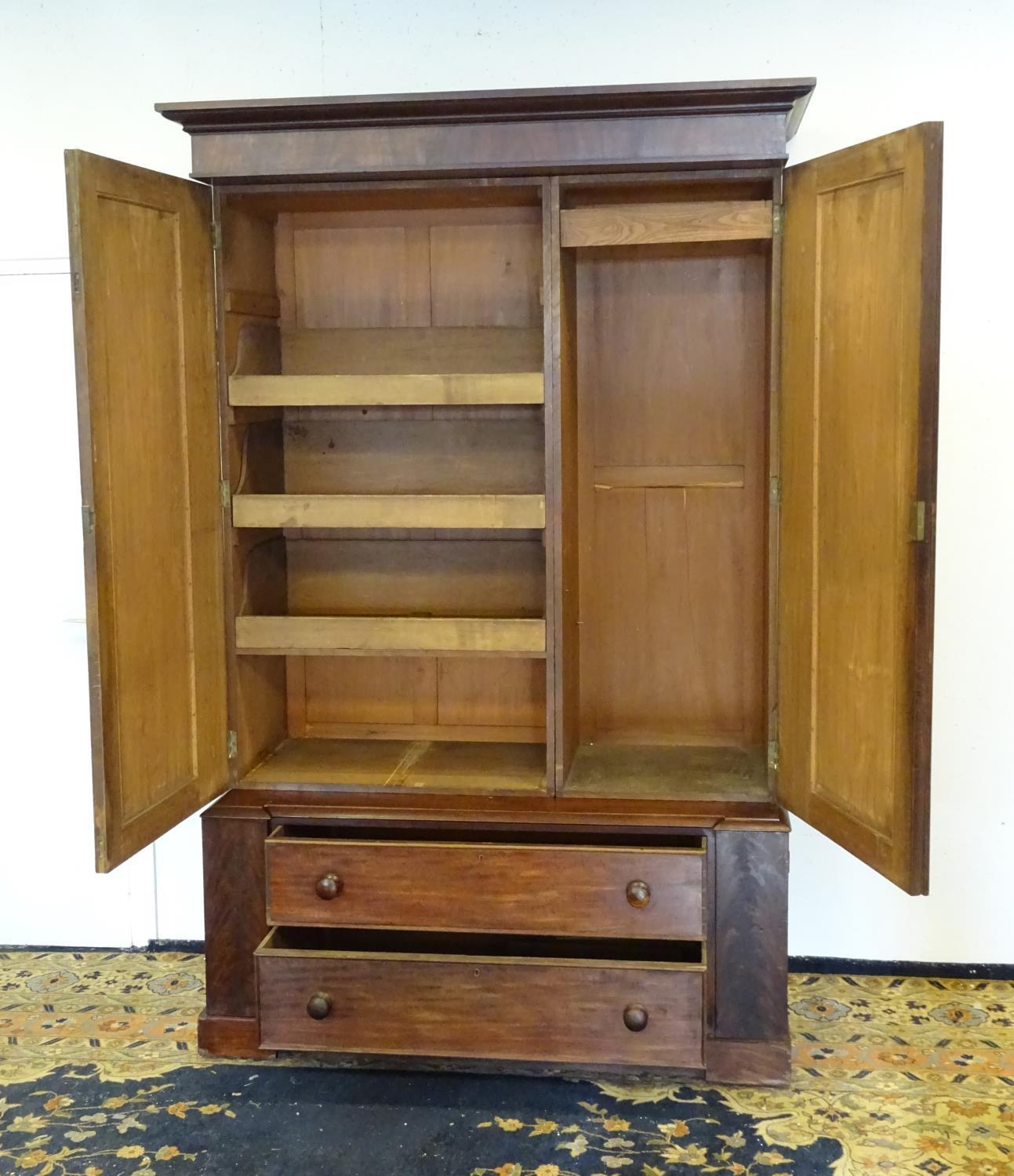 A 19thC mahogany press with a moulded cornice above two large doors with lancet shaped panelling, - Bild 7 aus 7