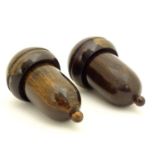 Two 19thC lignum vitae treen containers formed as acorns unscrewing to reveal a lead weight