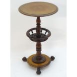 A 19thC mahogany tripod table with a circular top above a rounded under tier with turned finial