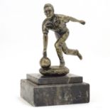 A 20thC cast figure modelled as a man bowling, on a stepped marble base. Approx. 5 1/4" high