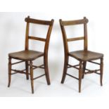 A pair of early 20thC side chairs with pegged chamfered top rails above shaped seats and turned