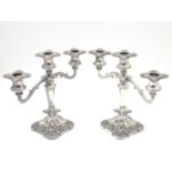 A pair of silver plate candelabra with fruiting vine decoration . Approx 10" high Please Note - we