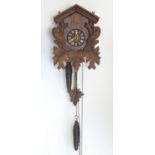A mid - late 20thC cuckoo clock, with ' Regula 'movement and 2 cast pine cone fomred weights.