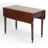 A 19thC mahogany Pembroke table with drop flaps and short end drawer, the table raised on turned
