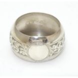 A silver napkin ring with engraved acanthus scroll decoration. Hallmarked Birmingham 1921 maker