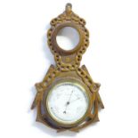 A Victorian aneroid barometer by Field & Son, Aylesbury, the carved oak case decorated with naval