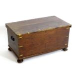 A late 19thC camphor wood military trunk with brass corner brackets, wrought iron carrying handles