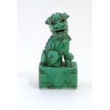 A Chinese model of a seated dog of foo with a green glaze. Approx. 6 3/4" high Please Note - we do