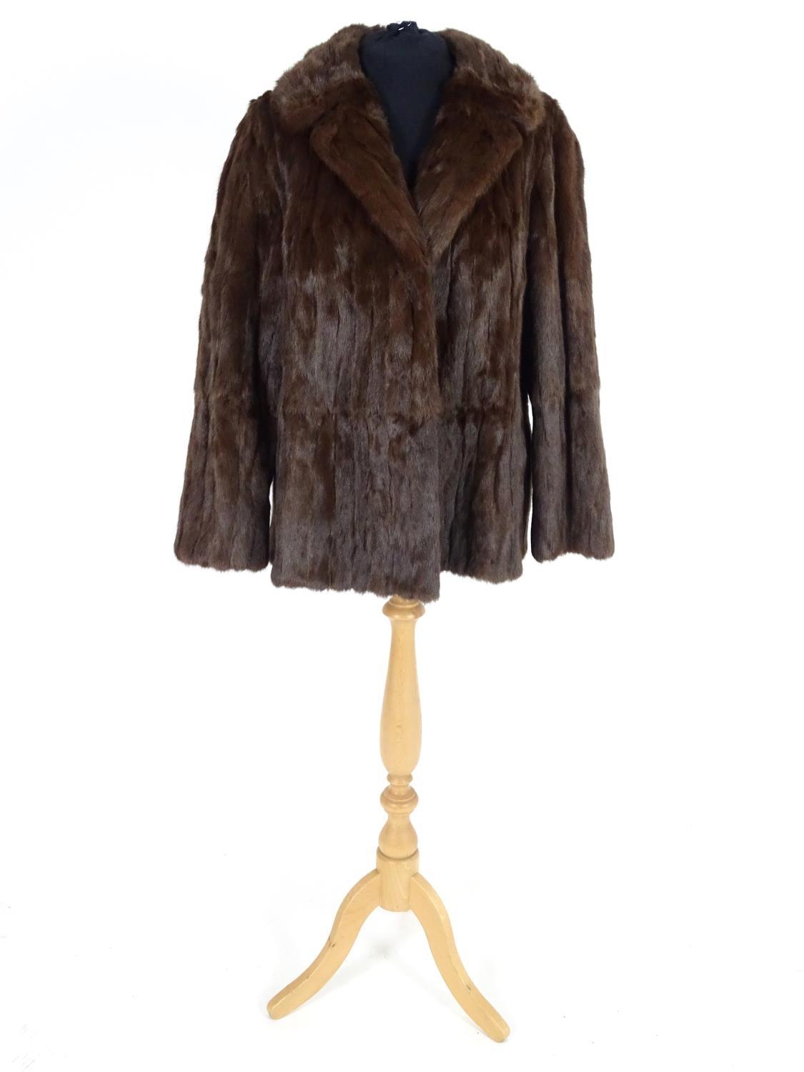 A vintage short length fur coat. Bust size 38" approx Please Note - we do not make reference to