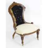 A Victorian slipper chair for re upholstery. Having a carved frame with roundel decoration and