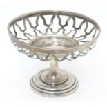 A silver openwork pedestal bonbon dish on weighted base. Hallmarked Birmingham 1909 maker