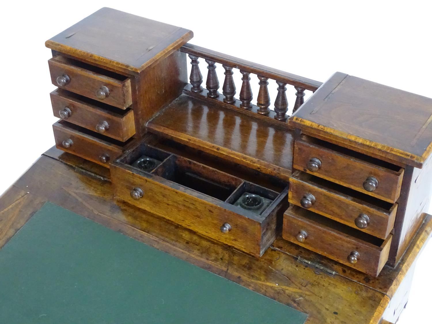 A mid / late 19thC walnut davenport with two banks of three short drawers together with a central - Bild 6 aus 8