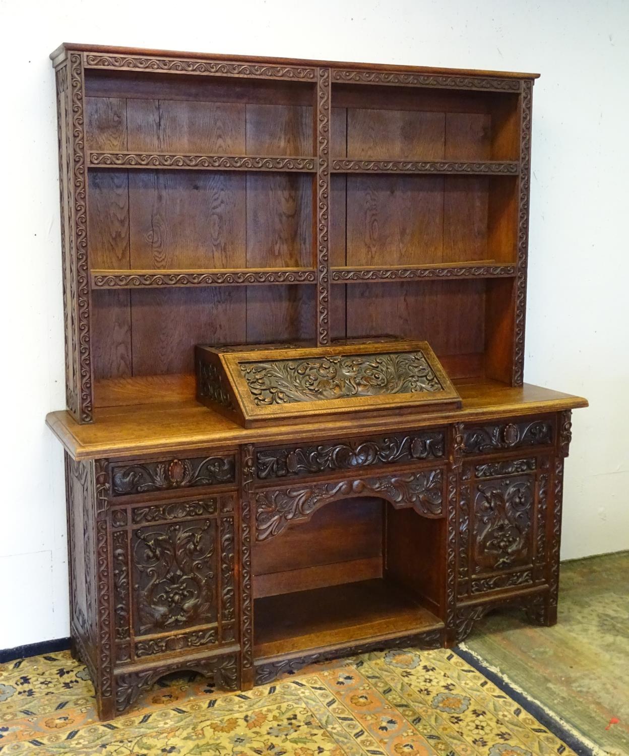 An early 20thC dresser with a blind fretwork carved plate rack above a carved slope and three - Bild 3 aus 5