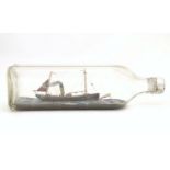 A 20thC ship in a bottle / diorama depicting Kindred Star LT177, a steam trawler boat at sea.