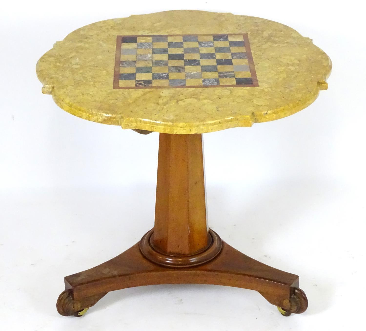 A Victorian marble top table with a shaped top and games board to centre, the bottom having a