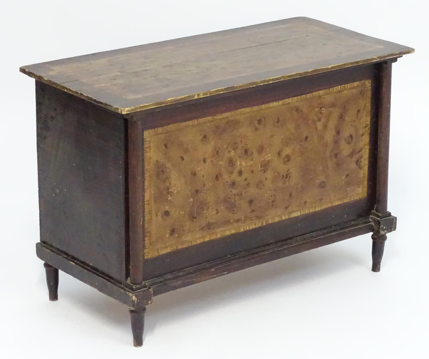 An early 20thC scumbled pine painted box with turned columns to the face and raised on turned