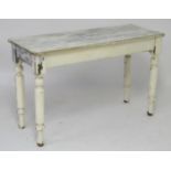 A late 19thC / early 20thC white painted side table with a rectangular planked top above four turned