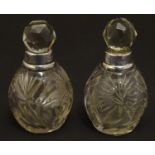 A pair cut glass scene / perfume bottles with silver collars . Hallmarked London 1911 maker Hart &