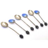 A cased set of six silver and enamel coffee bean spoons, the handles with coffee beans decoration,